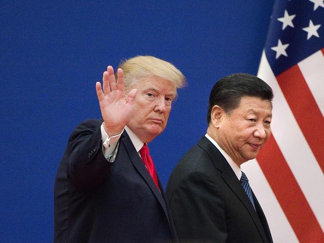 (FILES) In this file photo taken on November 9, 2017 shows US President Donald Trump (L) and China's President Xi Jinping leaving a business leaders event at the Great Hall of the People in Beijing. - President Donald Trump on September 18, 2018 accused China of seeking to influence upcoming US elections by taking aim at his political support base in the countries' escalating trade war. "China has openly stated that they are actively trying to impact and change our election by attacking our farmers, ranchers and industrial workers because of their loyalty to me," Trump tweeted.Trump's comments came a day after he targeted another $200 billion in Chinese imports with tariffs starting next week, drawing an immediate vow of retaliation from Beijing. (Photo by Nicolas ASFOURI / AFP)