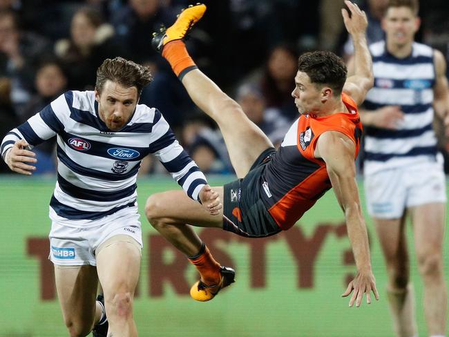 Josh Kelly flies for a mark over the top of Zach Tuohy.