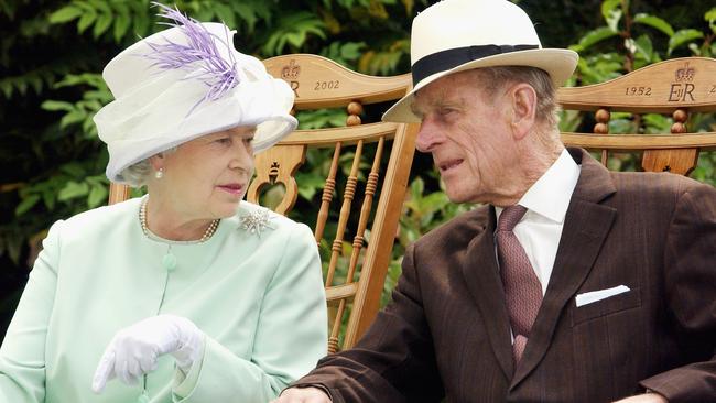 Queen Elizabeth II and Prince Philip, the Duke of Edinburgh chat while watching a musical performance in the Abbey Gardens during her Golden Jubilee visit to Suffolk in 2018. Picture: Getty Images.