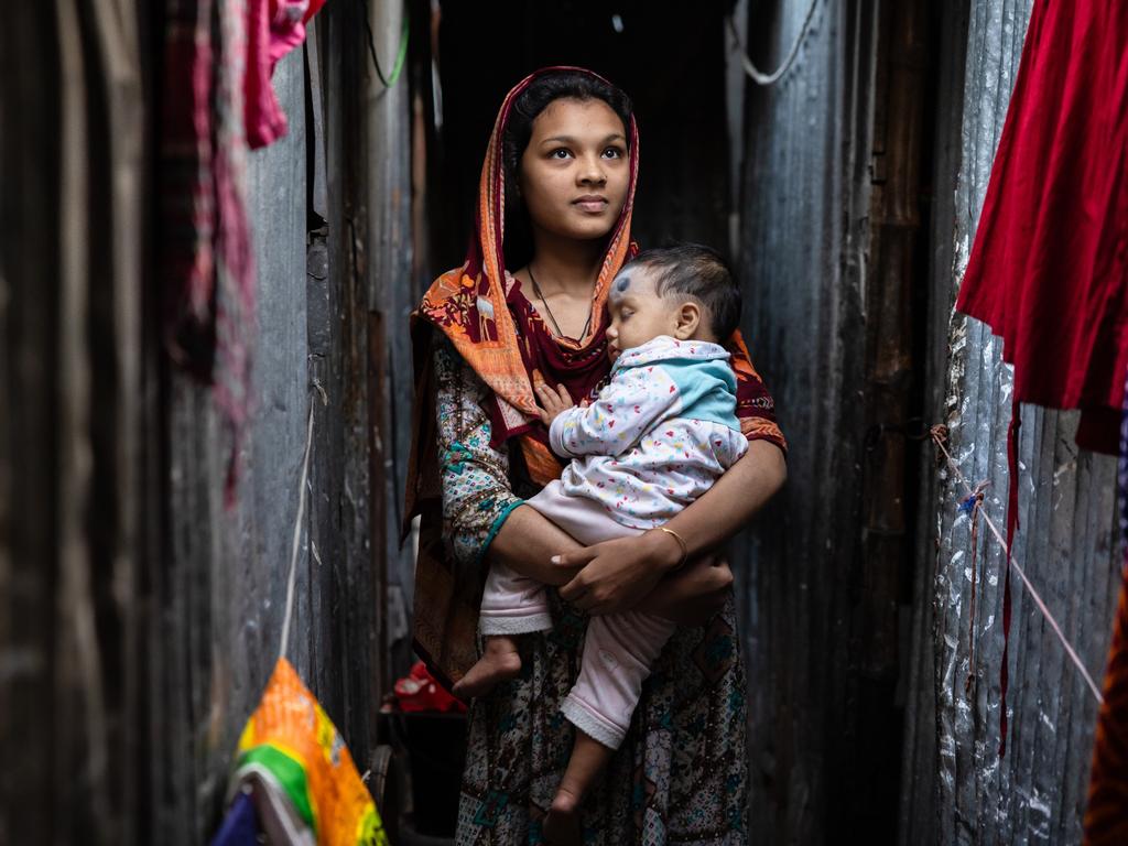 Mum Brishti, 16, and daughter Afsiya, 11 months old. They live in a one room hut with her husband of three years, who works in a grocery shop, her mother-in-law and brother-in-law. . Picture: Jason Edwards