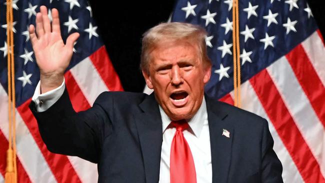 Former US President and Republican presidential candidate Donald Trump waves at the end of a live interview with US commentator Tucker Carlson in the finale of the Tucker Carlson Live Tour at Desert Diamond Arena in Glendale, Arizona, on October 31, 2024. (Photo by Patrick T. Fallon / AFP)