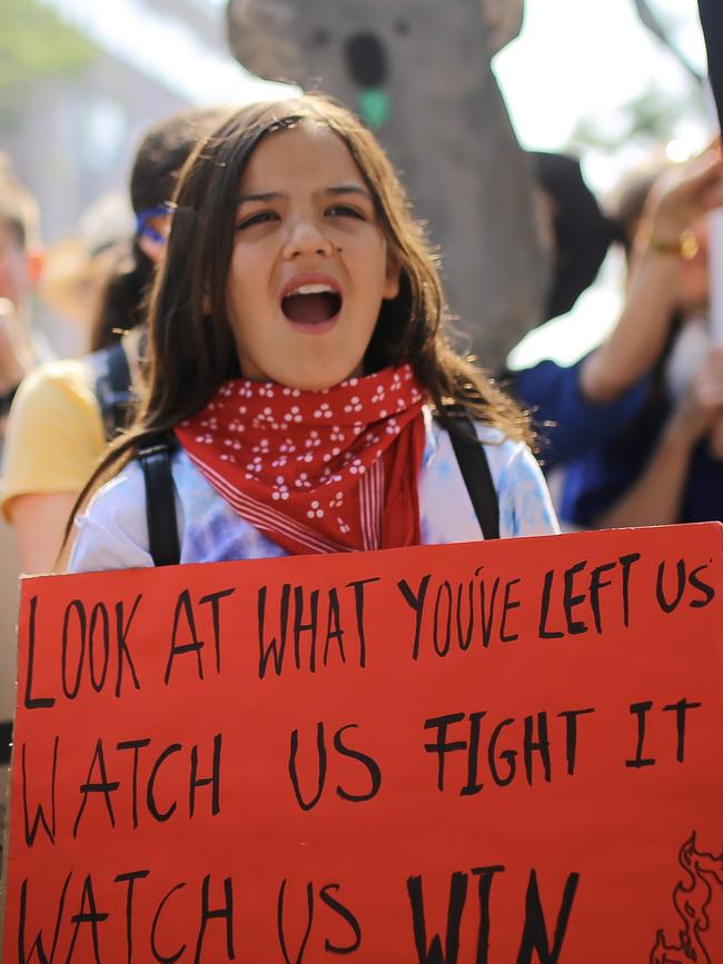 A girl protests outside Kirribilli House in Sydney. Picture: AAP Image/Steven Saphore