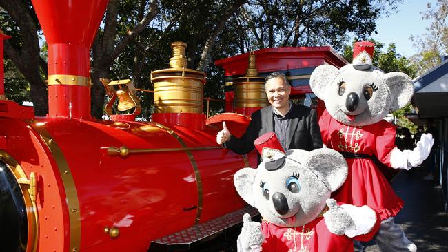 Greg Yong at the refurbished Dreamworld Express with mascots, Belinda and Kenny. Picture: Tertius Pickard