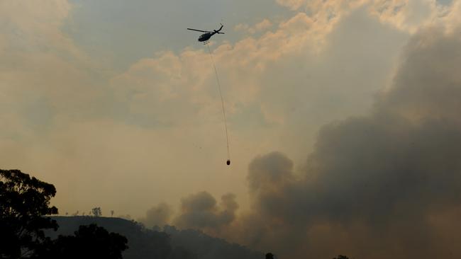 Helicopters water bomb as a bushfire burns in the Warrumbungle National Park. Picture: AAP