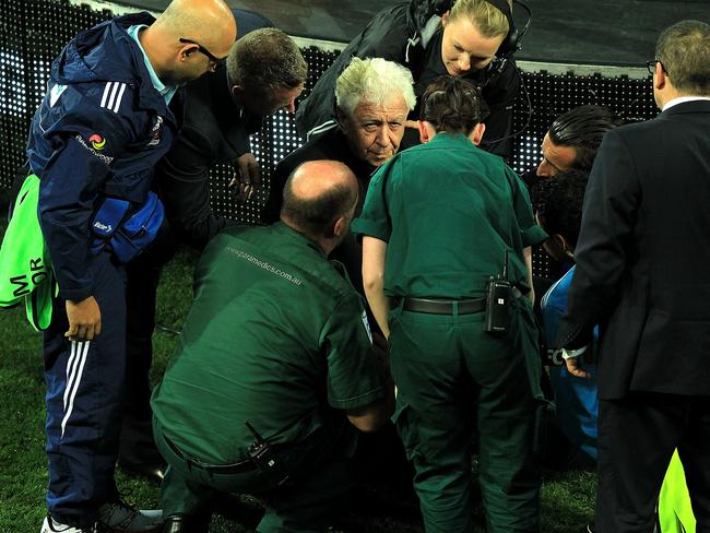 Lowy is attended to by paramedics.