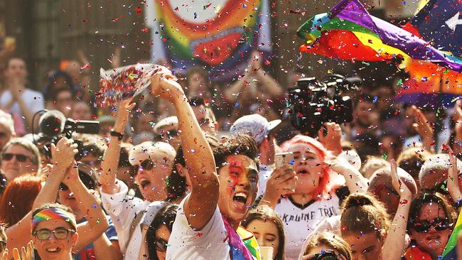 Yes supporters celebrate at the State Library of Victoria yesterday after the result of the same-sex-marriage postal survey was announced. Picture: Scott Barbour