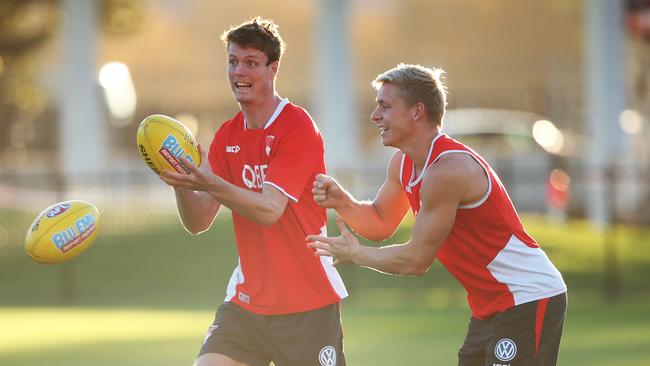 Isaac Heeney, right, with teammate Nick Blakey at training.