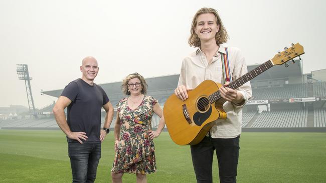 Fletcher Pillon poses for a photograph with Star 104.5FM presenters Rabbit & Julie Goodwin at Central Coast Stadium. Picture: Troy Snook