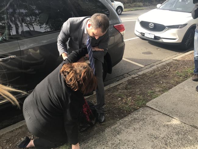 Lydia Abdelmalek’s mother trips as lawyer John Yianoulatos helps her up, while leaving the Heidelberg Magistrates Court in Melbourne. Picture: Christine McGinn/AAP