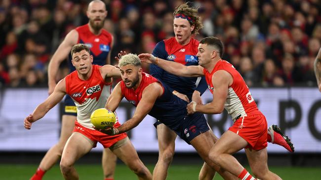 Christian Salem fires out a handpass under fierce pressure. Picture: Quinn Rooney/Getty Images