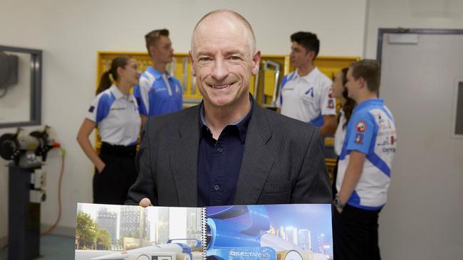 Penrith Christian School Head of Innovation and Technology, Martin Bishop holds a portfolio of the car entered in the F1 in Schools World Finals in Abu Dhabi, United Arab Emirates. Picture: AAP Image/Angelo Velardo.