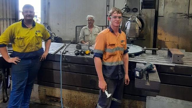 At Cairns-based engineering firm NQEA, Machine Shop Supervisor John Bohle (centre) with staff including apprentice Daniel Cotter (left) and Daniel White (right) in the workshop.