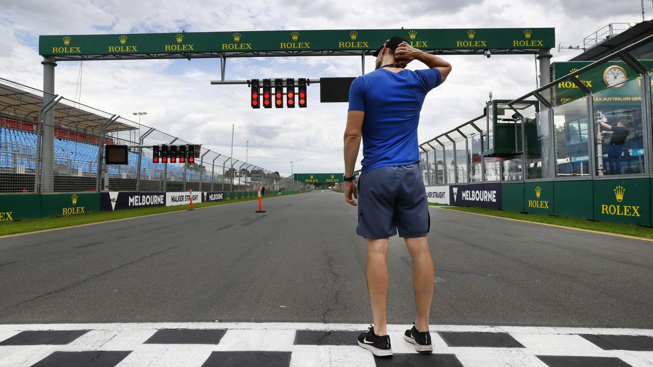 Track Doctor Ashley Hague standing on the finish line in disbelief after the Australian Grand Prix was cancelled due to coronavirus fears. Picture: David Caird.