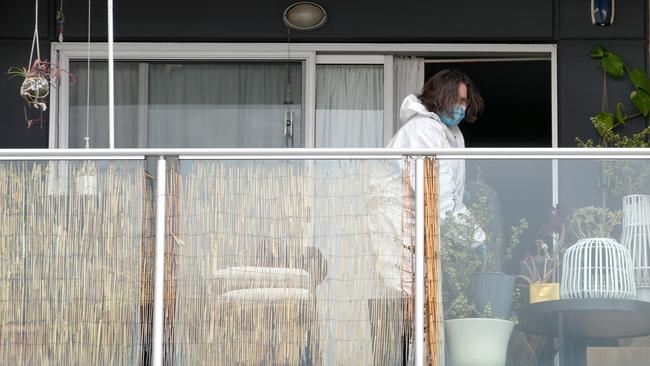 A forensic officer on the balcony. Picture: Dean Martin