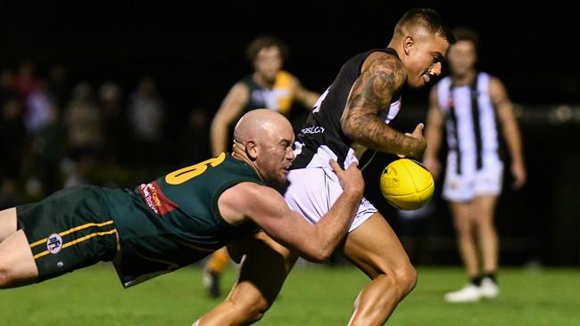 Northcote Park's Paul Dirago tackles Montmorency's Ben Kennedy. Picture: Nathan McNeil