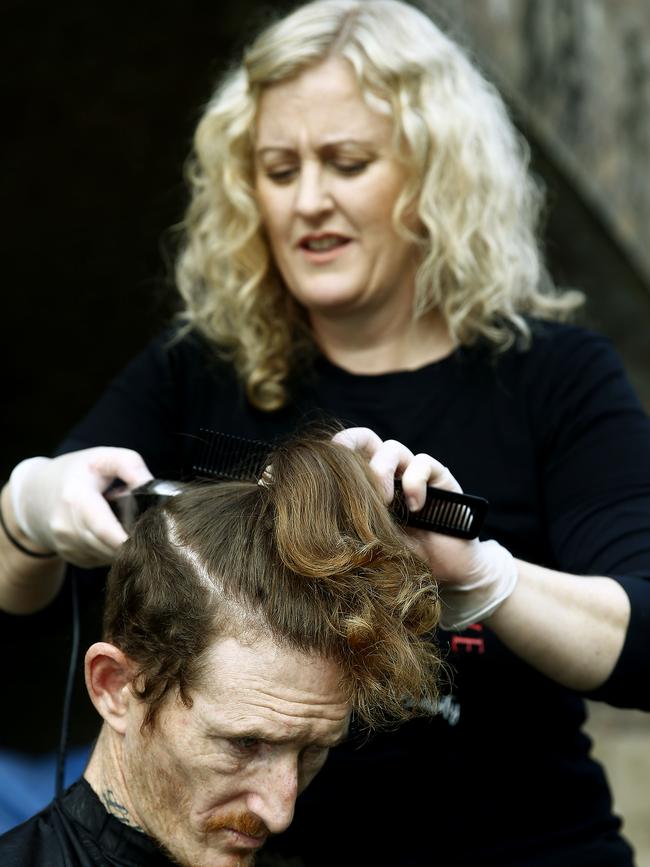 Beth Shannon from Hair on the Move cuts Sam’s hair. Picture: John Appleyard