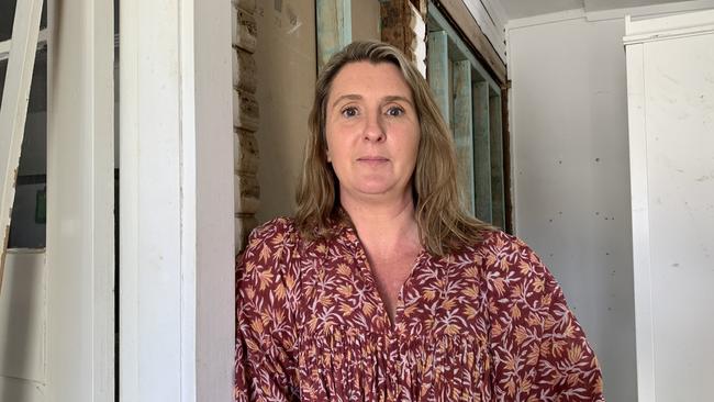 Lismore Mum Courtney Murphy had her home destroyed in the February floods. Five months later the Two Rooms community project was at her home installing donated gyprock for two rooms. Picture: Cath Piltz