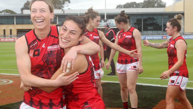 Sophie Van De Heuvel and Alana Barba celebrate Essendon’s fourth and final win of the inaugural season. Picture: Sarah Reed/AFL Photos via Getty Images