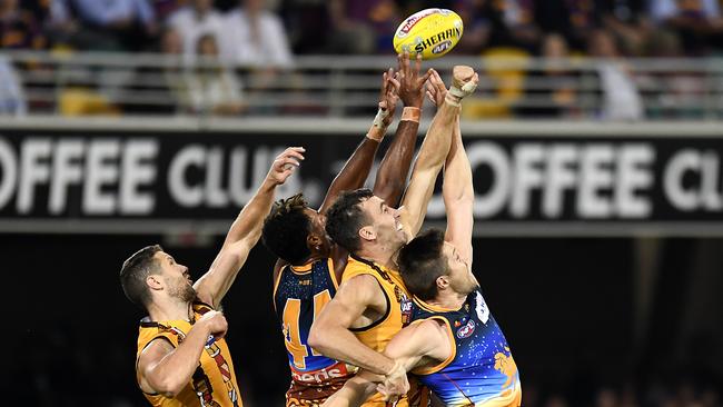 The big men fly ... Hawks James Frawley and Jonathan Ceglar compete with Lions Archie Smith and Stefan Martin. Pic: Getty Images