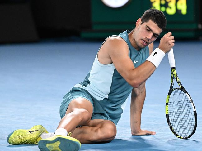 Down and out … Alcaraz falls on the court during his loss to Djokovic Picture: AFP