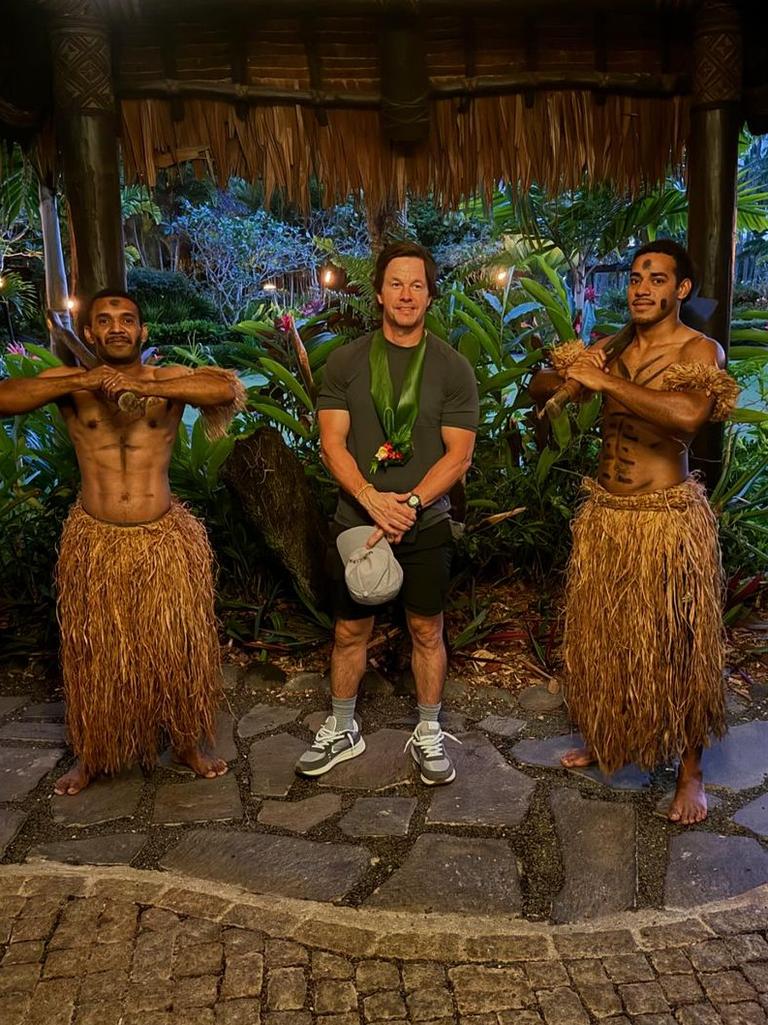 Wahlberg poses with locals at the resort.