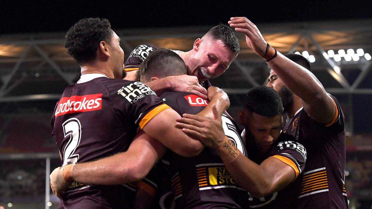 Corey Oates of the Broncos is congratulated by teammates after scoring a try. Picture: Bradley Kanaris/Getty Images