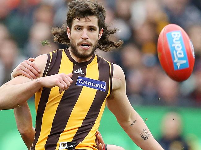 AFL Round 20. 04/08/2018. Hawthorn v Essendon at the MCG.  Hawthorn's Ben Stratton gets a kick away as he is tackled from behind by Essendon's Orazio Fantasia .Pic: Michael Klein