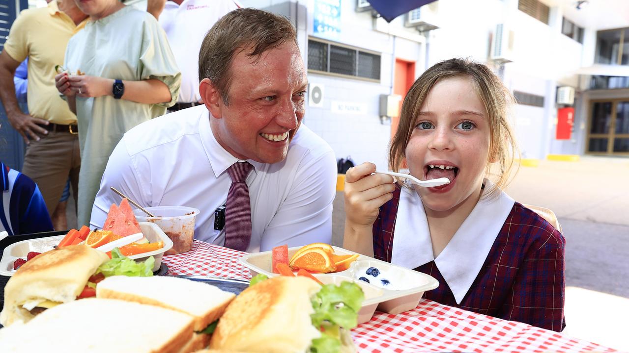 Steven Miles, with Indi Berrill, 7, in Cairns, promised free lunches for primary school students if Labor was re-elected. Picture: Adam Head