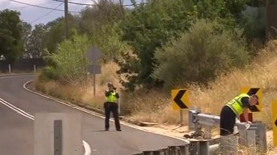 Police on Norton Summit Rd, where a car collided with a cyclist. Picture: 7NEWS