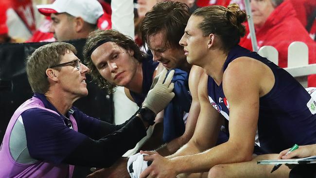 Hamling is assisted on the bench after copping a Buddy elbow. Picture. Phil Hillyard