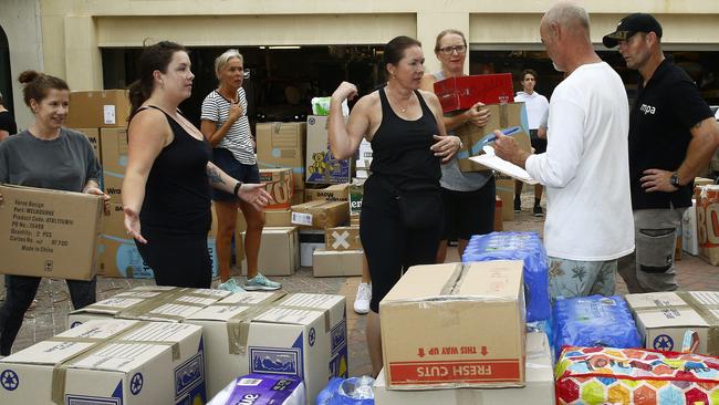 Volunteers sort donation boxes ready to be loaded onto a truck at Bondi Surf Bathers Life Saving Club who have been inundated with donations after setting up as a bushfire relief centre. Picture: John Appleyard