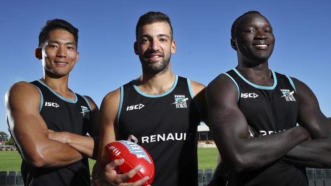 Chen Shaoliang, Jimmy Toumpas and Emmanuel Irra at Alberton Oval. Picture: Sarah Reed