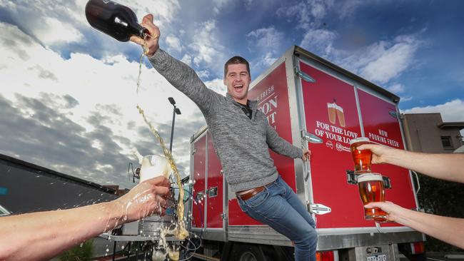 Jono Brown rides on the Carlton &amp; United Breweries truck. Picture: Alex Coppel