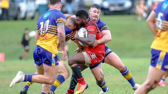 Sherwin Tanabi hit by the Mullum defence. Picture: DC Sports Photography