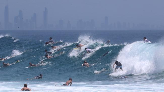 Surfers enjoy large waves at Snapper Rocks .Picture Mike Batterham