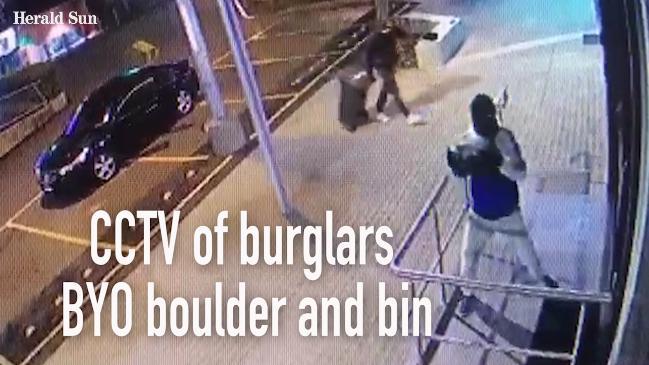 CCTV of burglars BYO boulder and bin 