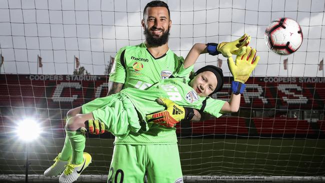 Adelaide United supporter Ace Kounavis with Reds goalkeeper Paul Izzo at Hindmarsh Stadium. Picture: Sarah Reed