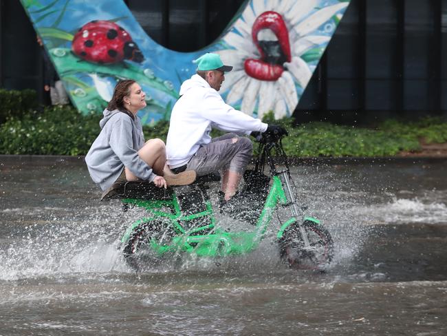 People ride through floodwaters in Clarendon St. Picture: David Crosling