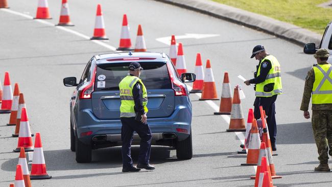 Police and army at the Queensland border. Picture: NIGEL HALLETT