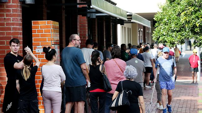 People lined up at Centrelink in Cairns CBD in March after strict social distancing laws were introduced. . PICTURE: STEWART McLEAN