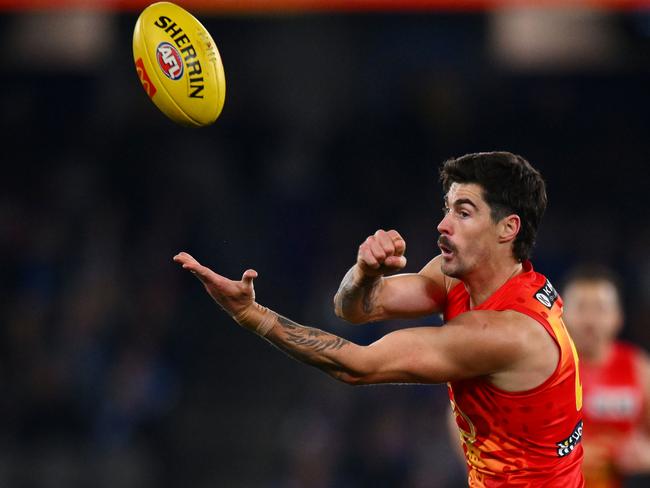 Alex Sexton of the Suns handballs during the round 17 AFL match between North Melbourne Kangaroos and Gold Coast Suns at Marvel Stadium, on July 06, 2024, in Melbourne, Australia. (Photo by Morgan Hancock/AFL Photos/via Getty Images)