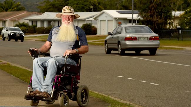 Kirwan resident Garth Brielow is frustrated that he can't get around town in his wheelchair because of cars parked on footpaths and broken pavers everywhere. Picture: Evan Morgan