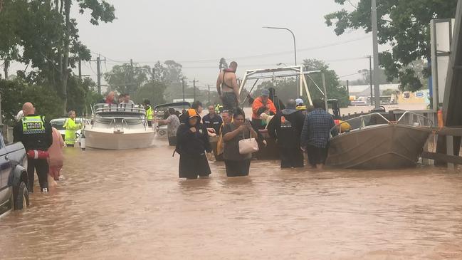 Rescue crews drop people off at the Ballina Street Bridge in South Lismore on February 28, 2022.