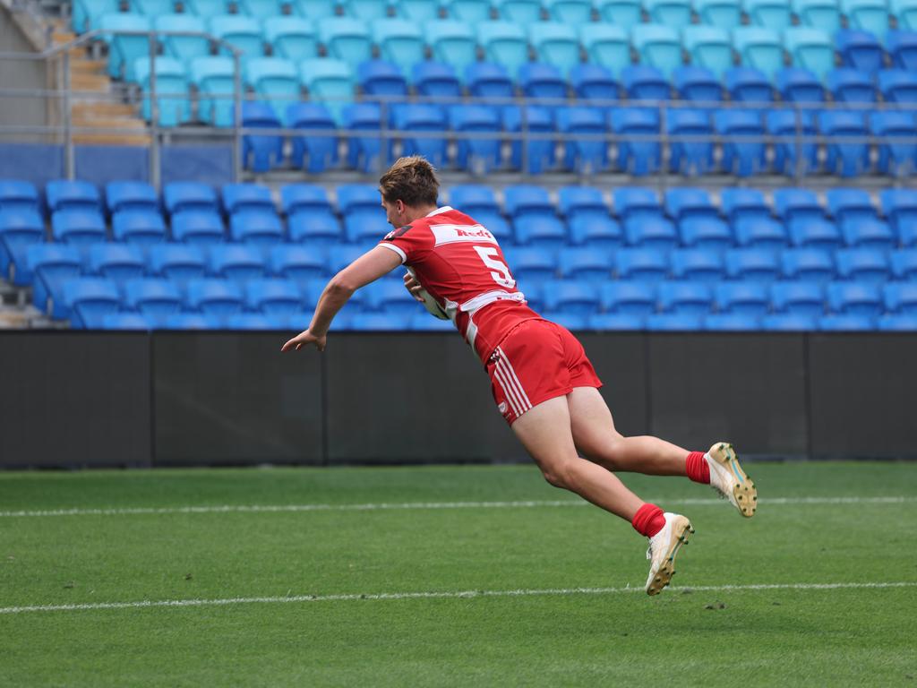 NRL National Schoolboys Cup final at CBUS Stadium between Palm Beach Currumbin and Patrician Blacktown Brothers. The Red Army and Palm Beach Currumbin 's Beau Hartmann scores the winning try and celebrates with team mates.. .Picture Glenn Hampson