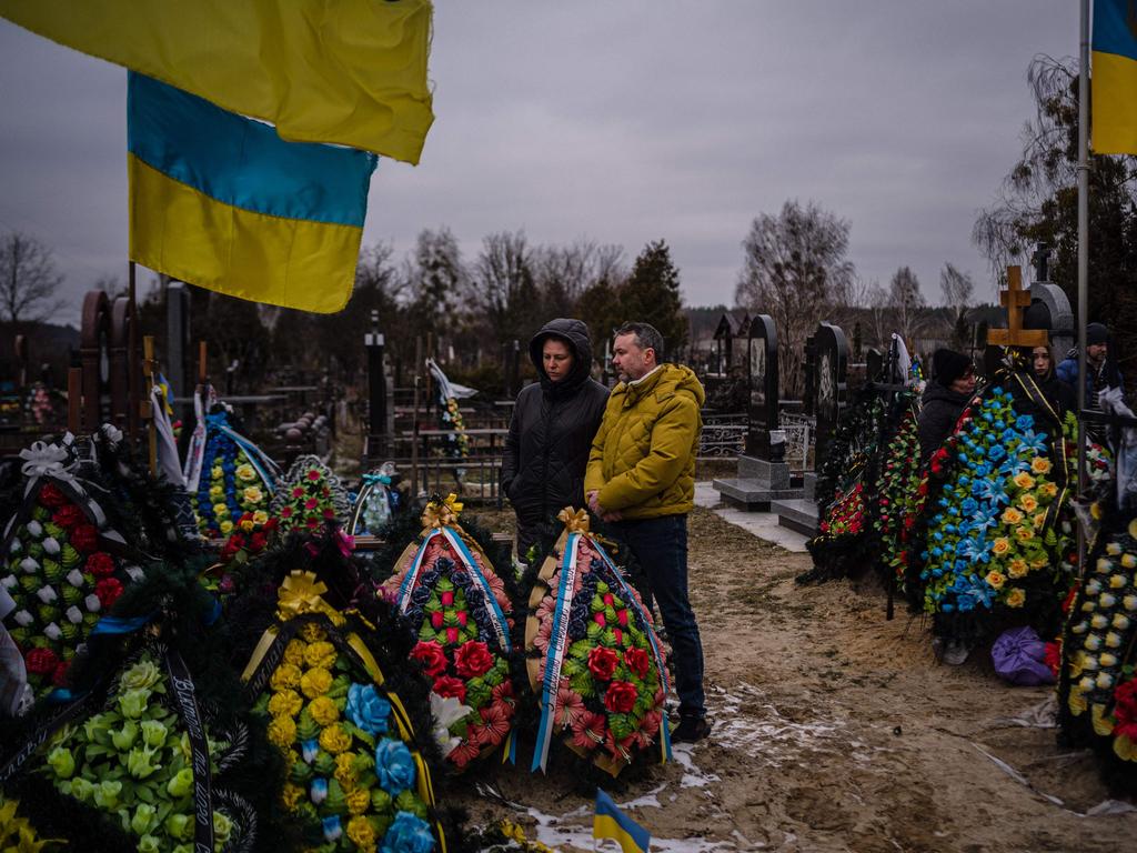 Family of a Ukrainian serviceman visit a cemetery in Bucha, near Kyiv, on the first anniversary of Russia’s invasion. Picture: AFP