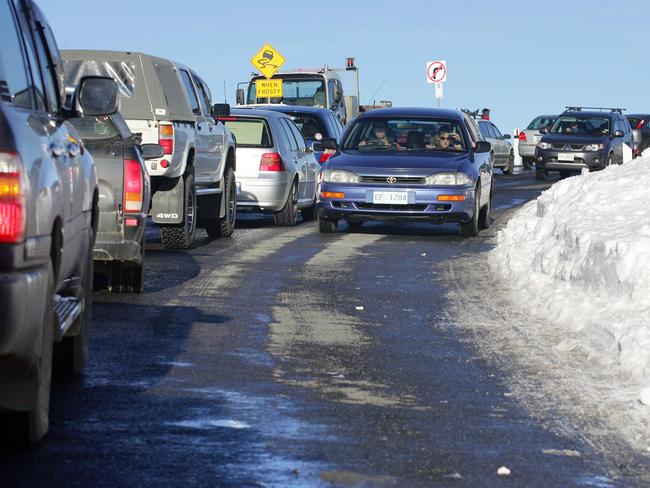 A long line of cars waits to access the Mt Wellington pinnacle during winter snow.