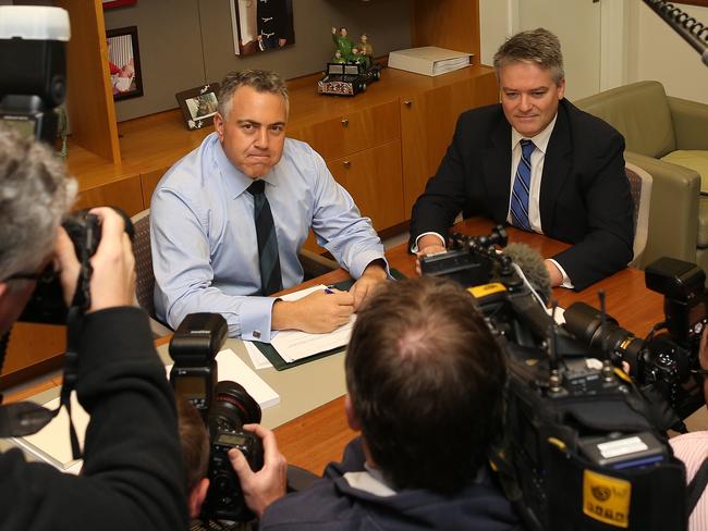 Joe Hockey at Parliament House with Senator Mathias Cormann, also prone to a cheeky dart apparently.