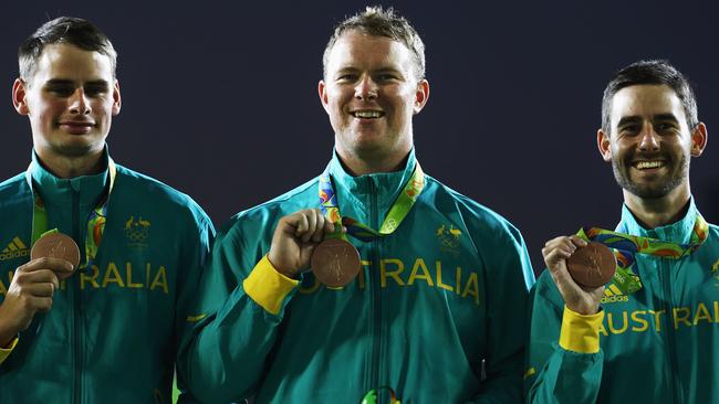 Alec Potts, Ryan Tyack and Taylor Worth celebrate with their archery bronze medals.