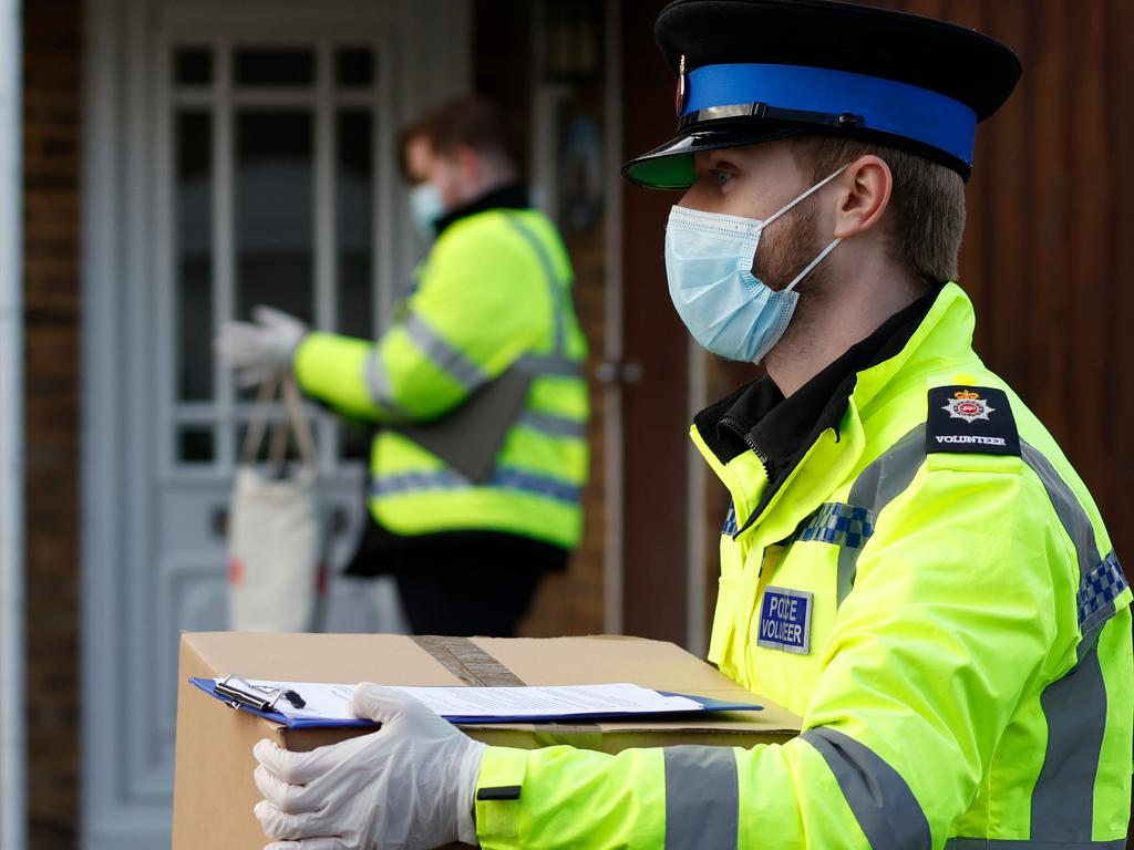 Police volunteers are helping to distribute COVID-19 testing kits to all residents in Woking, southwest of London, as authorities launch a blitz on the South African mutation. Picture: Adrian Dennis / AFP