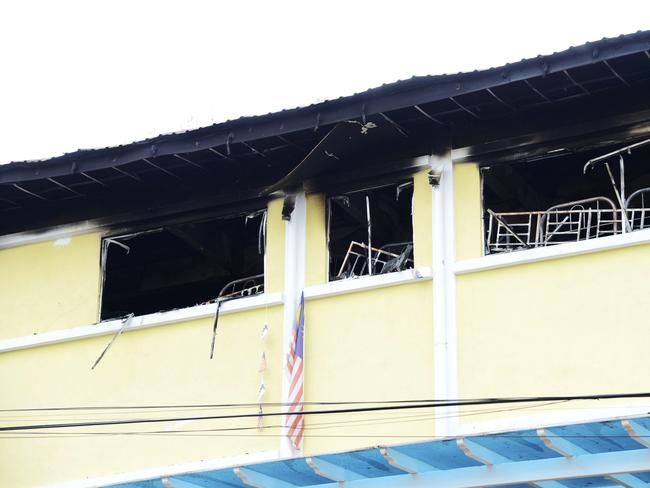 Burned windows of an Islamic religious school is seen after firefighters put out a fire on the outskirts of Kuala Lumpur. Picture: AP